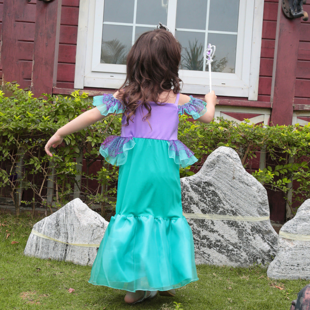 Mermaid gown in teal and purple with ruffle sleeves and waist on girl from behind