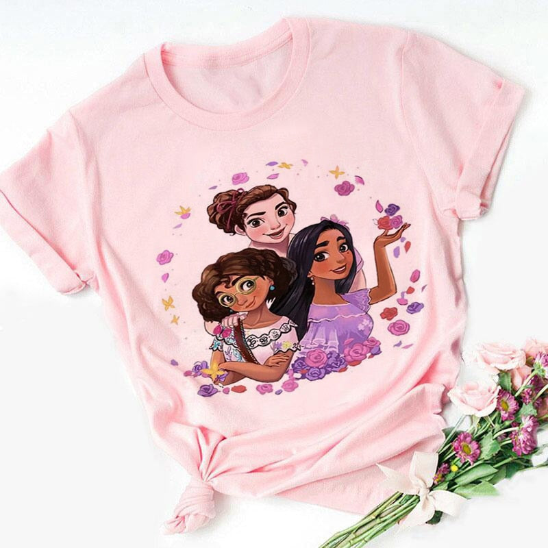 Girls pink t-shirt with flower graphic surrounding Mirabel, Isabella, and Luisa Madrigal from Encanto